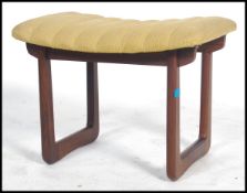 A 1960's teak dressing table stool having an unusual seat being raised on teak quadrille style legs.