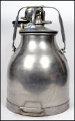 Dairy interest in the form of a vintage 20th century stainless steel milking churn with all the