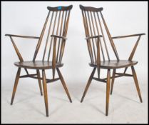A pair of mid 20th Century pair of Ercol  Goldsmith Windsor beech wood and elm carver dining