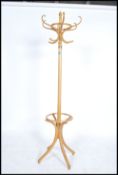 A vintage 20th century Thonet style bentwood hat stand being raised on splayed legs with s-shaped