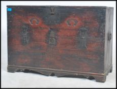 A 20th century Chinese campaign style hard wood chest, having a hinged brass details, fall front