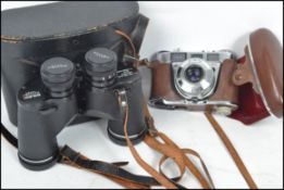 A vintage cased pair of 20th century binoculars by Pentax along with a vintage Retinette camera