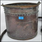 A 19th century Victorian Dairy interest copper coal scuttle, having an armorial coat of arms to