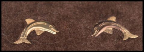 A pair of 9ct gold earrings in the form of dolphins having post backs. Unmarked but tests as 9ct.