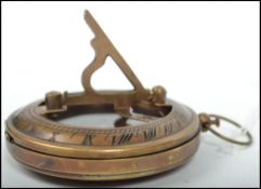 A 20th century brass cased compass of military design bearing notation to the verso together with