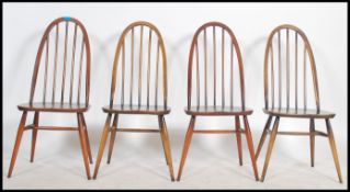 A set of 4 20th century Ercol windsor pattern beech and elm dining chairs with saddle seats and