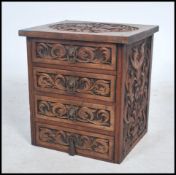 An early 20th century carved wood bedside of small proportions having an intricate carved Chinese