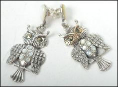 A pair of silver and moonstone ladies earrings in  the form of owls, each with hooks
