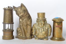 Two vintage 20th century brass money boxes one in the form of a postbox and the other in the form of