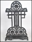 A Victorian 19th century aesthetic movement cast iron two section stick stand in the manner of