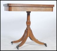 A Regency revival 20th century mahogany card table having a flip over baize lined games top with