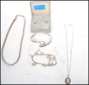 A group of sterling silver jewellery to include a silver two strand rigid cross over bangle 23.5