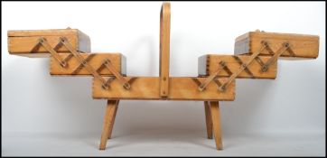 A vintage 20th century retro metamorphic sewing box with contents having ebonised detailing along