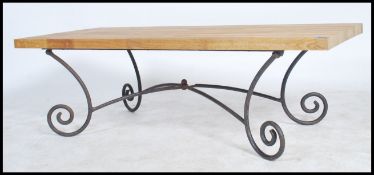 A retro 20th century wrought iron scroll work coffee table base having a later, large rectangular