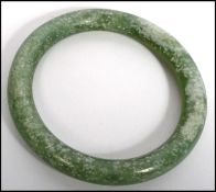 A vintage green jade bangle bracelet along with a graduating apple coral necklace with s hook
