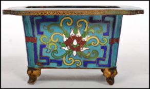 A 19th century turquoise ground cloisonne bonsai jardiniere decorated with floral splays and