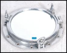 A vintage 20th century nautical ships mirror porthole having a chrome body , central glass panel