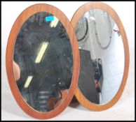A pair of 1970s teak frameless oval mirrors. Measures 0.5cms x 56cms x 36cms.