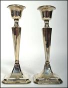 A matching pair of silver hallmarked silver candle sticks but each having different assay marks