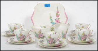 A vintage art deco Shelley part tea service in the Hollyhocks pattern RNo 823343 consisting of cups,