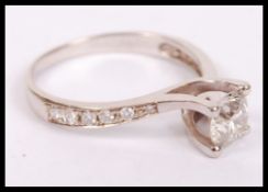 A good 14ct white gold and diamond cross over sing