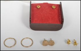 Four pairs of 9ct gold earrings. Total weight 2.4g excluding non gold backs.