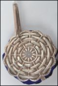 A vintage sterling silver ladies pin cushion on bail in the form of a wicker wheel with a blue baize