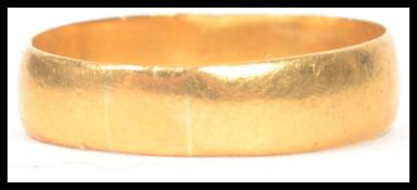 A 22ct hallmarked gold band ring of usual form with plain finish, weighing 3.2g and