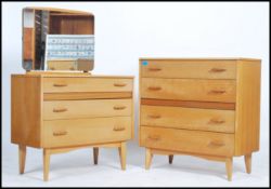 A retro 1970's straight 6 chest of drawers with gilded handles and raised on turned legs together