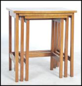 An early 20th century nest of walnut tables. Each of graduating size being raised on squared legs