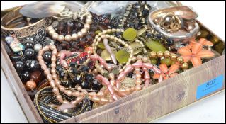 A collection of vintage costume jewellery to include necklaces, beads, bangles etc.