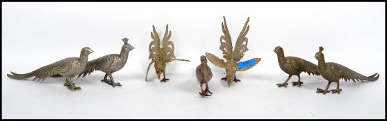 A pair of silver plated fighting cock together with a brace pair of silver plated pheasants and
