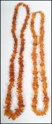 Two vintage baroque amber necklaces one having a barrel clasp  one measuring 28 inches and one