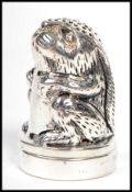 A contemporary novelty silver thimble being in the form of a rabbit complete with a pin cushion (