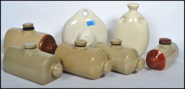 A collection of vintage 20th century stoneware ceramic hot water bottles of varying form and shape