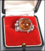 A fantastic sterling silver polish ring with a large baltic honey amber stone set in a detailed