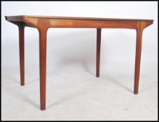 Agood 1970's teak wood retro Mcintosh dining table of rectangular form extending with flip over