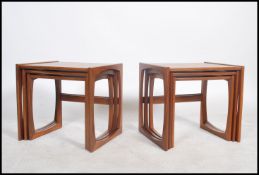 A pair of good 1970's retro G-Plan '  Quadrille ' nest of tables being raised on squared legs with
