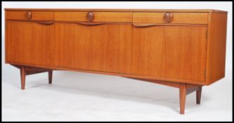 A good 1970's Danish inspired teak sideboard being raised on square tapered legs with a series of
