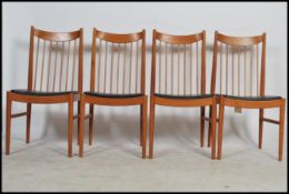 A set of 4 retro 20th century  teak wood spindle backed dining chairs with faux leather black