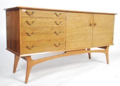 A good mid century Alfred Cox laurel wood / walnut sideboard raised on tapering legs having a shaped