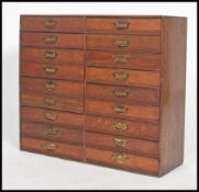 An oak 1930's haberdashery double bank chest of drawers being of small proportions comprising of