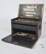 A mid century work / tool box comprising of an ebonised oak frame being brass bound. The interior