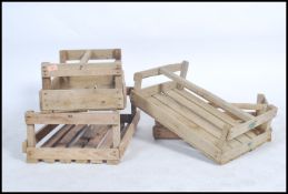 A collection of 5 unusual wooden mid century apple crates of slatted construction having carry