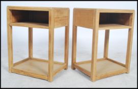 A pair of mid century oak Air Ministry bedside tables. Each with open recess and over squared legs