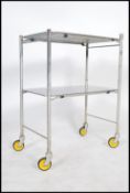 An original mid century Industrial surgeons theatre trolley of tubular metal and stainless steel