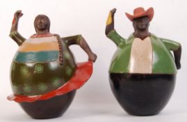 A pair of unusual large Peruvian terracotta handpainted oversized character figurines of a lady