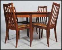 A stunning G-Plan teak extending dining table. Raised on tapered support with pierced and