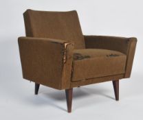 A mid century retro armchairs - wedge chair being raised on turned and tapering legs with angular