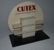An original early 20th century Cutex shop display stand in two tone colourway with Art Deco style